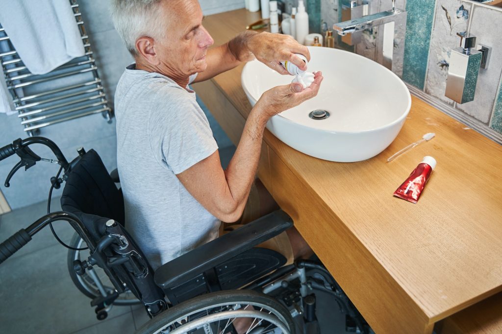 Male with disability pouring shaving cream on his palm